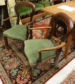 A set of ten Victorian style mahogany balloon back dining chairs to include two carvers with green