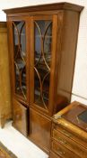 A mahogany display cabinet with two astragal glazed doors and fluted pilasters surmounted and