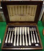 A Victorian silver 12 place fish knife and fork set with filled handles (by JRM over EW in italics