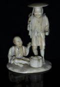 A Japanese Meiji Period carved ivory okimono as two shellfish fishermen,