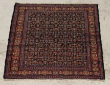 A Caucasian rug, the midnight blue ground with all over repeating pattern in burnt red and cream,