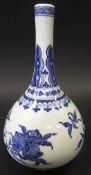 A Chinese blue and white gourd shaped vase with pomegranate and peach decoration,