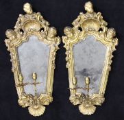 A pair of gilded terracotta framed girandole mirrors in the rococo taste,