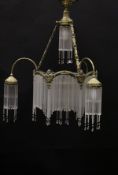 An early to mid 20th Century gilt brass and glass drop electrolier in the style of Hector Guimard,