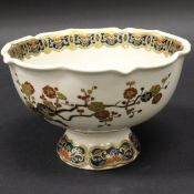 A Japanese Meiji period satsuma ware bowl decorated with bands of scrolling foliage and flowers,