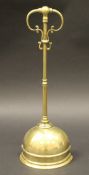 A Victorian brass doorstop with open scrollwork handle on a domed base, 44.