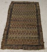 A Caucasian tribal rug, the centre field with repeating hook motifs on a camel ground,