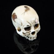An early 20th Century Japanese carved ivory half skull with shibayama style decoration of frog and