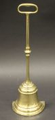 A Victorian cast brass doorstop with loop handle on a brass bell type base, 39.