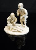 A Japanese Meiji Period carved ivory okimono as two woodsmen, one standing, one kneeling,