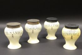 A set of four early 19th Century cream ware pharmaceutical drug jars of accentuated baluster form,
