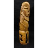 An African craved ivory fertility symbol of phallic form as a male and female nude standing back to