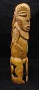 An African craved ivory fertility symbol of phallic form as a male and female nude standing back to
