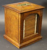 A circa 1900 mahogany coin collector's cabinet with brass carrying handle over an arched glazed