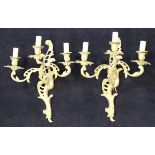 A pair of 20th Century gilt brass three branch wall sconces in the rococo taste with Chippendale