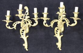A pair of 20th Century gilt brass three branch wall sconces in the rococo taste with Chippendale