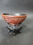A 19th Century Chinese cinnabar lacquered bowl, decorated in relief with five toed air dragons,