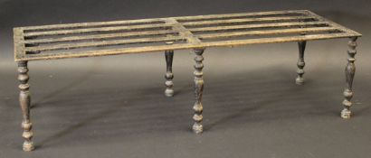 A 19th Century cast iron trivet, the slatted two part top on six baluster turned and ringed legs,
