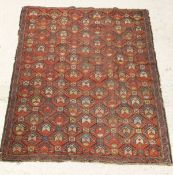 A Kazak rug, the all over repeating pattern in salmon pink, burnt orange, harvest barley,