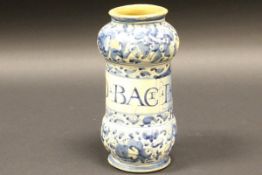 A late 17th / early 18th Century faience drug jar with all over blue and white scrolling floral
