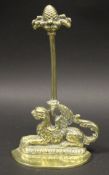 A Victorian cast brass doorstop as a seated Griffin with pineapple handle, 34.