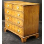 An oyster walnut and mahogany banded square chest of two short over three long graduated drawers in