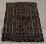 A Bokhara rug, the thirty-nine elephant foot guls on a red ground,
