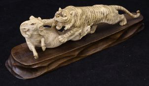 A Japanese Meiji Period carved ivory figure group as a tiger attacking a goat and kid, 23 cm long,