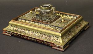 A Victorian red tortoiseshell and brass inlaid boulle work decorated desk stand with central glass