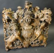 A George III carved oak Royal Coat of Arms in high relief in the manner of Grinling Gibbons