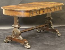 A 19th Century mahogany library table in the Gillows manner with flamed mahogany top and rounded