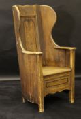 A 19th Century painted pine lambing chair, to simulate oak,