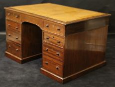 A late 19th Century mahogany pedestal desk with tooled leather inset top above two frieze drawers