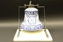 A 19th Century Dutch Delft wall mounted bell decorated with insignia of the Dutch East India