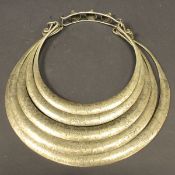 A 20th Century Tibetan engraved white metal necklace or collar as five concentric rings with