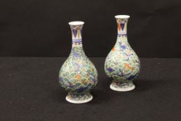 A pair of Chinese polychrome decorated gourd shaped vases,