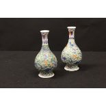 A pair of Chinese polychrome decorated gourd shaped vases,