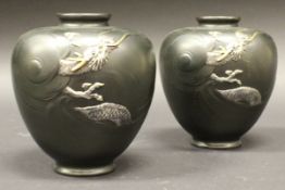 A pair of Japanese patinated bronze vases with silvered and gilt dragon decoration,