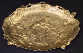 A gilt metal dish in the Art Nouveau manner depicting a slave trader inscribed within the casting