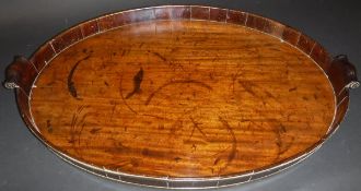 A George III mahogany and brass bound coopered oval drinks tray with scroll work handles, 77.