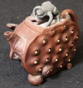 A 20th Century Yi Xing teapot as a cut lotus pod, the body with reticulated seeds,