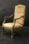 A 19th Century stained beech framed elbow chair in the 18th Century Flemish taste,