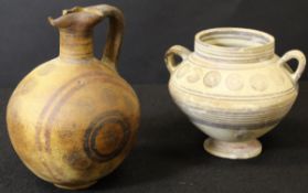 A Cypriot iron age pottery ewer or Oinochoe of globular form with roundel decoration,