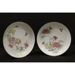 A pair of Chinese Qianlong porcelain chargers with famille rose spray decoration and butterflies to
