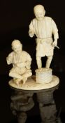 A Japanese Meiji Period carved ivory okimono as two men with basket of vegetables and leaves,