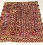 A Bokhara rug, the centre field with four rows of twelve elephant foot guls on a red ground,