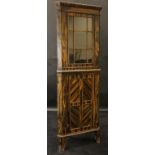 A 20th Century coromandel corner cabinet with single glazed door enclosing three shelves,