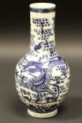 A Chinese blue and white gourd shaped vase decorated with five toed dragon amongst clouds and bats