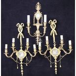 A pair of gilt brass four branch wall sconces in the Regency taste with ribbon tied support holding