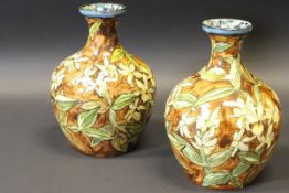 A pair of Doulton Lambeth faience vases with all over daffodil decoration,